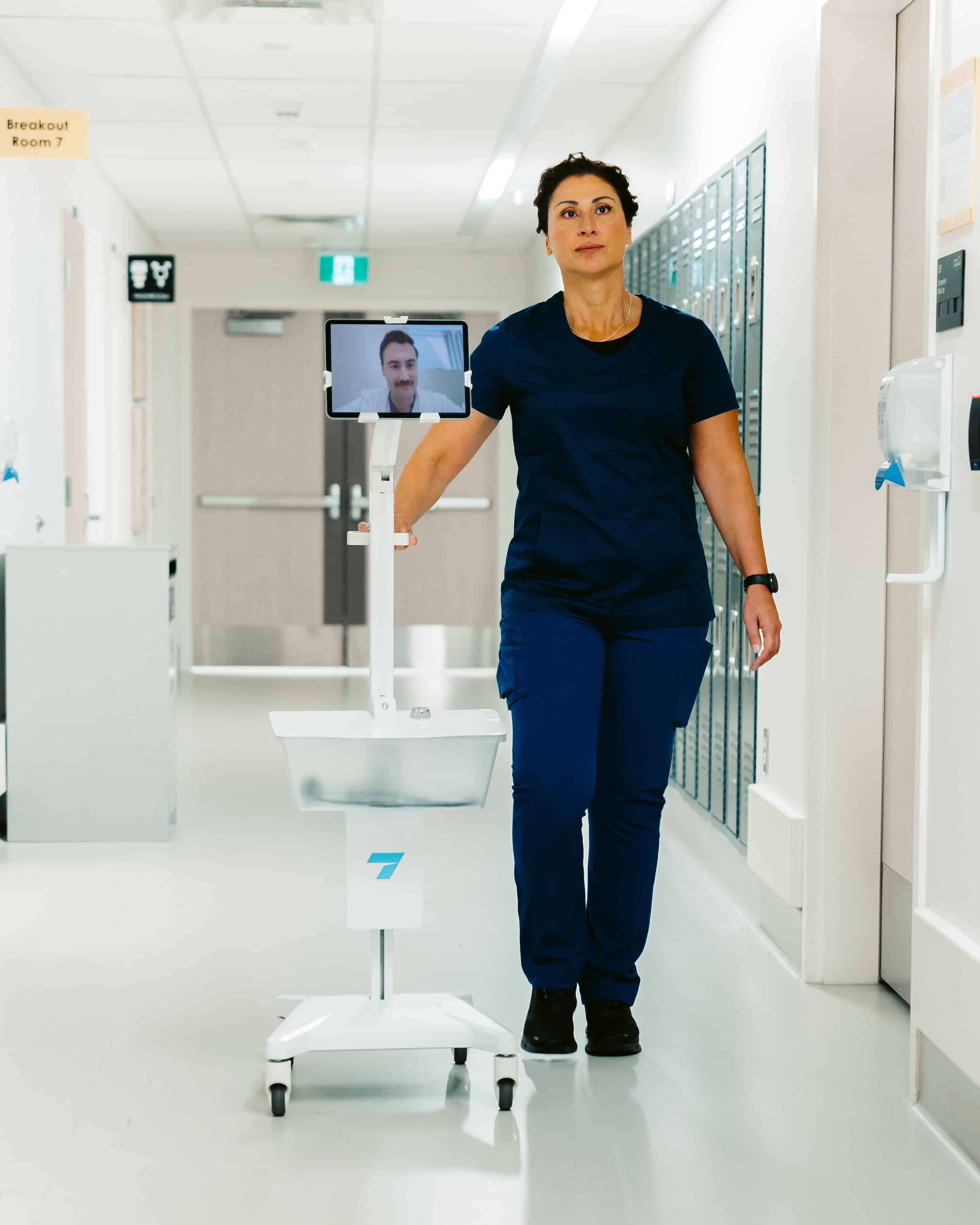 Doctor is rolling Tryten's tablet cart down the hall.